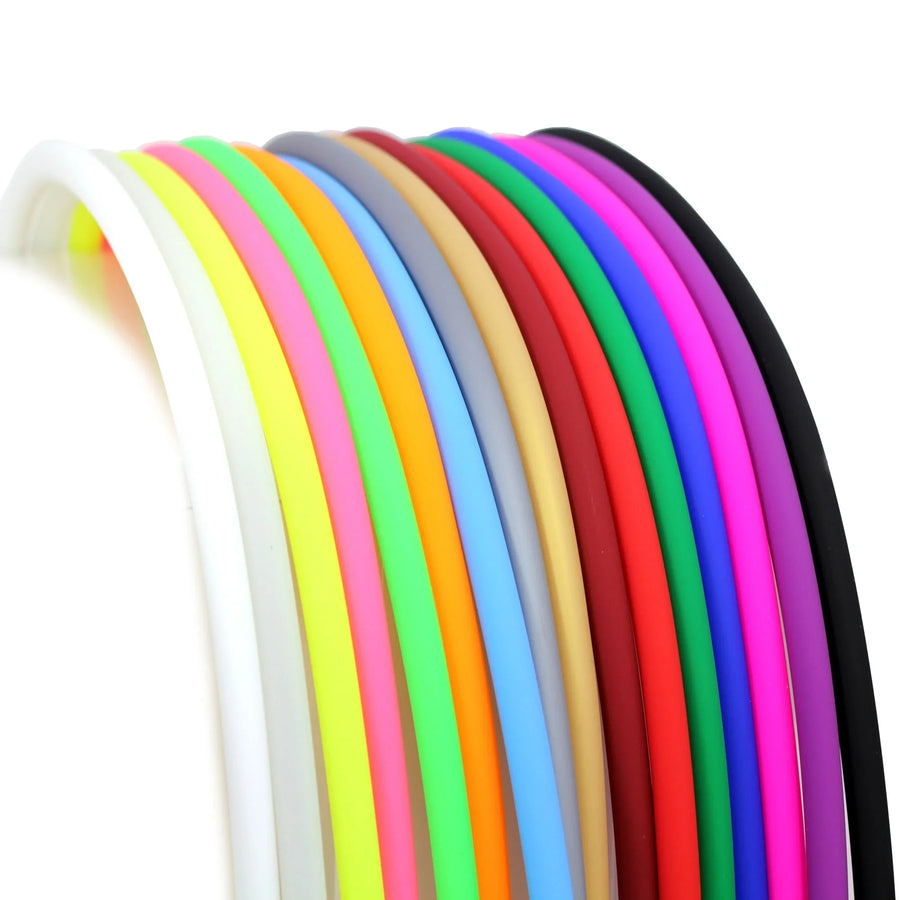 An arc of silicone hookah hoses in all sorts of colors side by side, from white and yellow through pink and blue to purple and black.