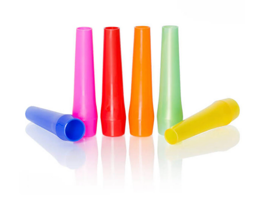 Six plastic hygienic mouthpieces in pink, red, orange, green, blue and yellow, some standing and some lying down.