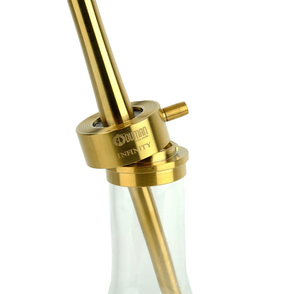 Gold block of the Oduman Infinity with its hose port above clear glass